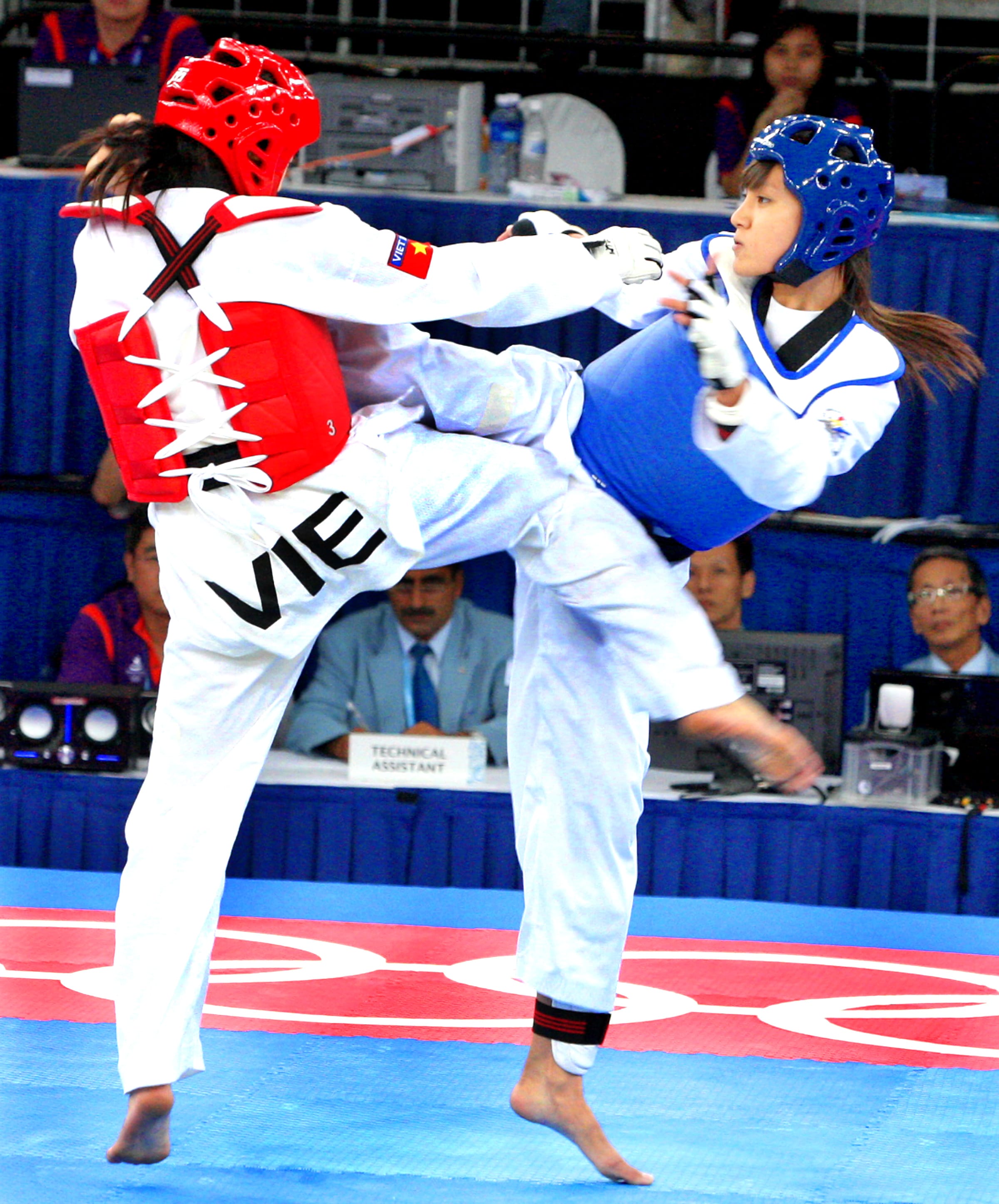 Singapore's taekwondo athlete, Nurul Shafinas Abdul Rahman (right), at the semi-final match during the Youth Olympic Games 2010. She won a bronze medal in the girls 55kg competition. The Straits Times/The New Paper © Singapore Press Holdings Ltd. Reprinted with permission.